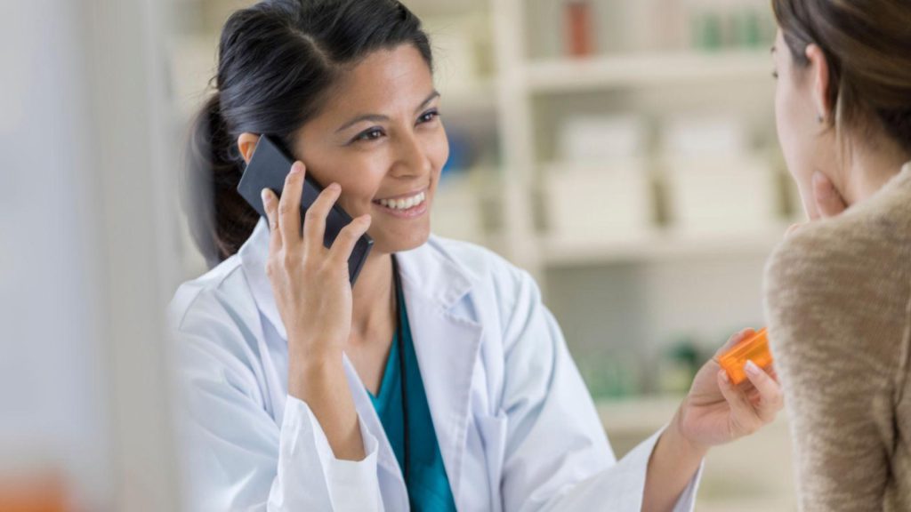 Pharmacist discussing medication and patient care in a community pharmacy