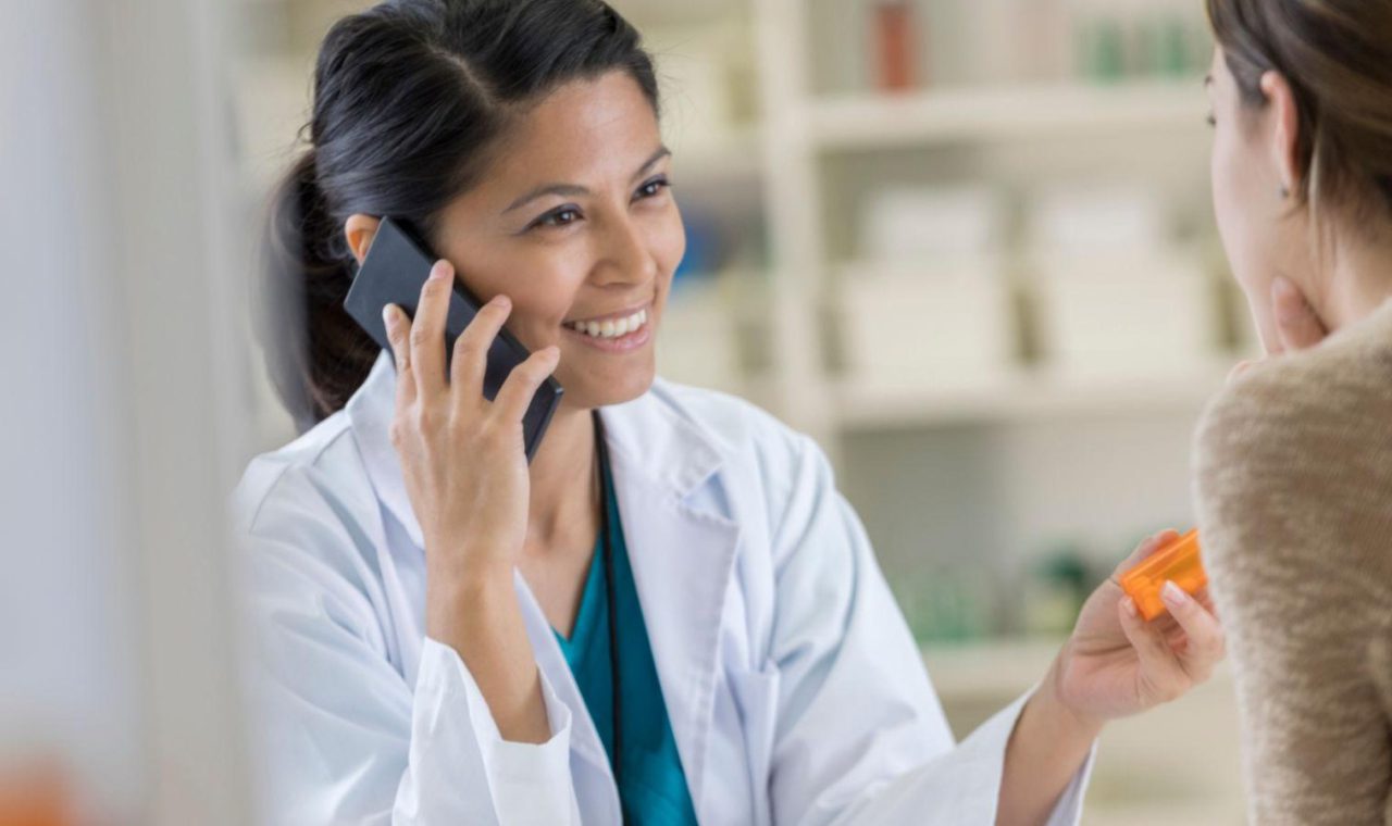 Pharmacist discussing medication and patient care in a community pharmacy