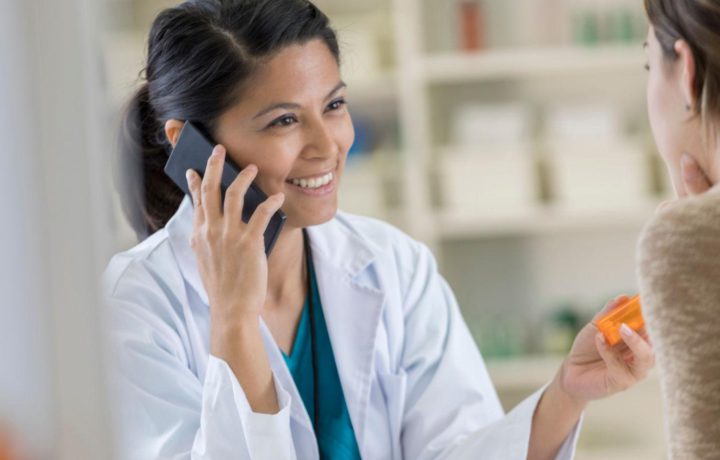 Pharmacist discussing medication and patient care in a community pharmacy